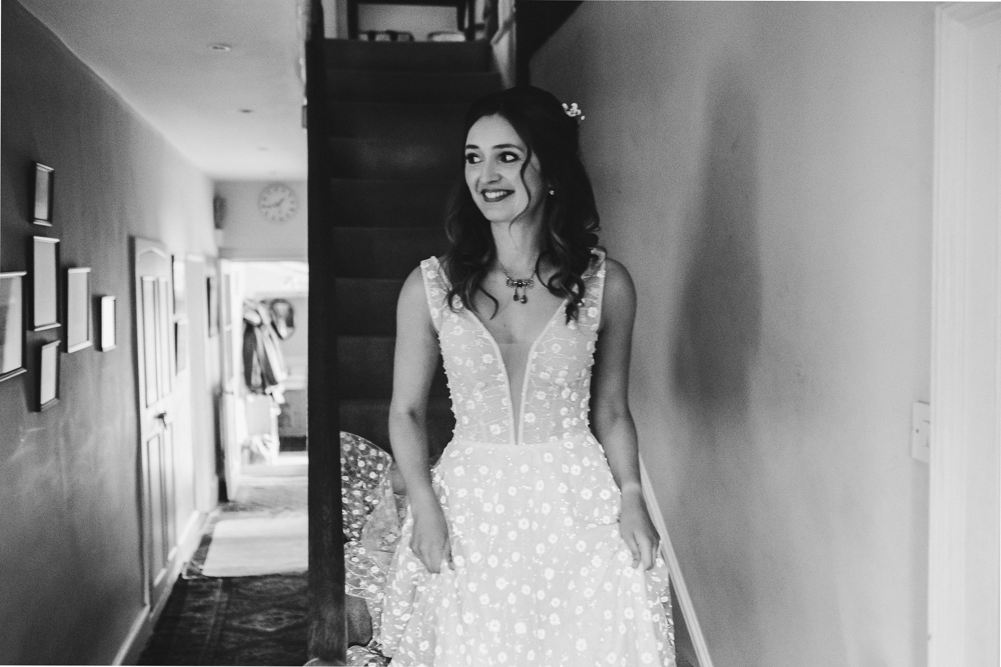 Caroline descends the stairs in her stunning Pronovias wedding dress